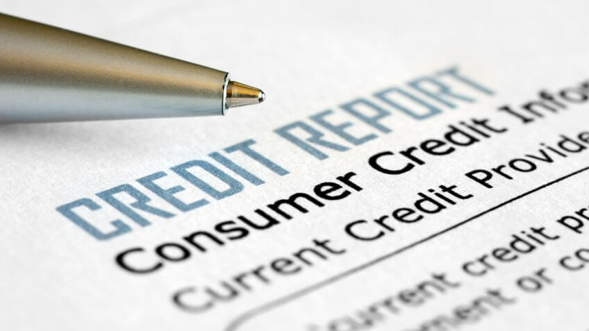 Close-up of credit report with pen.