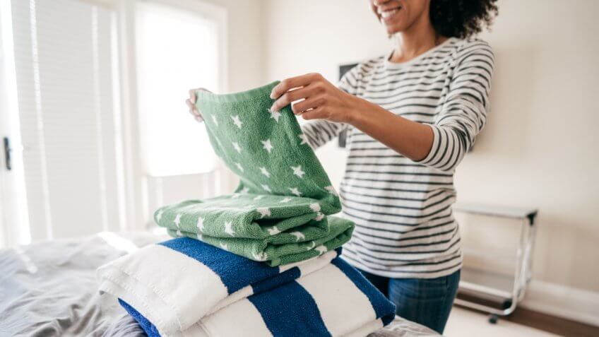 Woman folding towels.