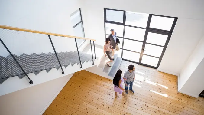 Real estate agent showing new house to couple - Image.