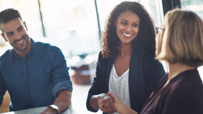Shot of two businesswomen shaking hands during a meeting in a modern office.