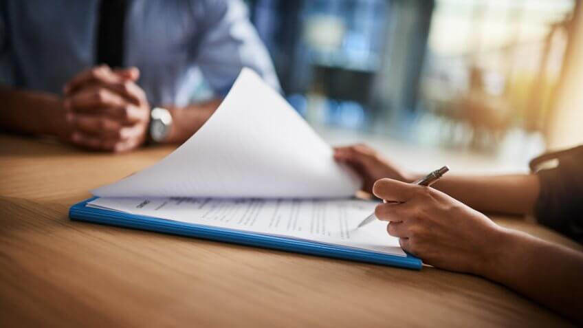 businesswoman filling out paperwork for her salary negotiation