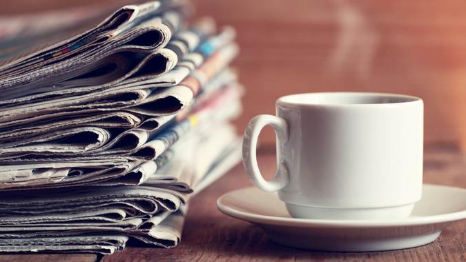 Newspapers and Coffee on table.