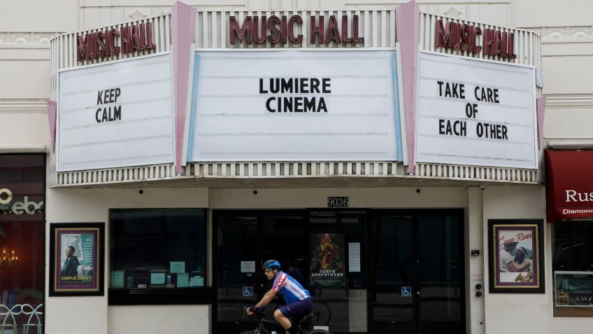 The closed Lumiere Cinema at the Music Hall theater displays a message to passersby during the state of California's shelter in place order due to the coronavirus SARS-CoV-2 which causes the Covid-19 disease in Beverly Hills, California USA, 20 March 2020.