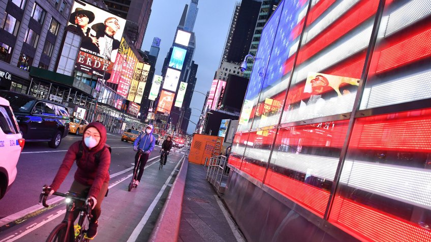 A cyclist wears a face mask in Times Square in Manhattan due to the Coronavirus outbreak.