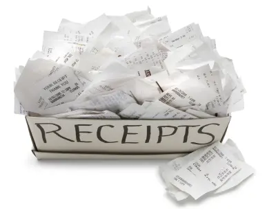 A full box of receipts with some spilling out