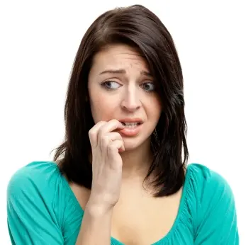 White woman nervously biting her finger nail