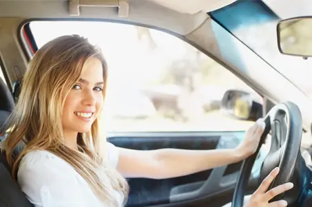 Smiling woman driving her car